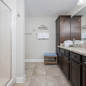 Refresh in the master bath after a day at the beach with a relaxing walk-in glass shower