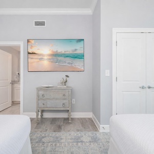 Unwind in this guest bedroom with two queens after a day at the beach with a TV streaming your favorite shows
