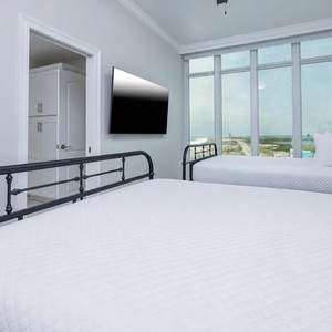 Stretch on a queen bed, grab the TV remote, and look at the beachfront from this guest suite