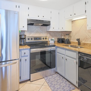 The kitchen features stainless appliances, granite countertops, and ample cabinetry for a delightful cooking experience