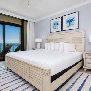 Retreat to the king master suite with stylish decor, fluffy pillows, and beachfront balcony access