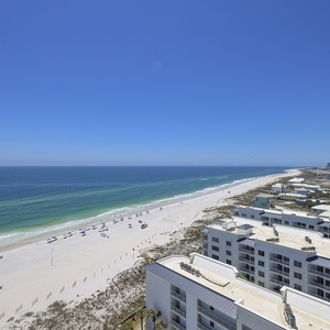Watch turquoise gulf waters lap the shoreline as beach canopies scatter below