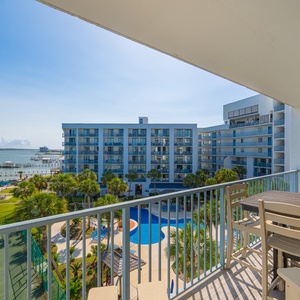 Savor the coastal views from your balcony while enjoying quality time at the cozy outdoor dining table