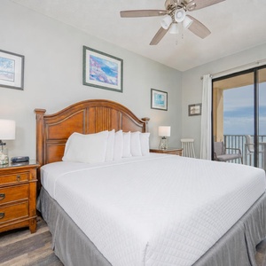 The master bedroom features a king bed, wooden furniture, and sliding doors leading to a balcony with beach views