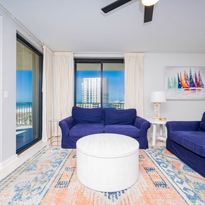 Relax on the plush sofa with queen sleeper while enjoying the vibrant decor and beach views from the large windows