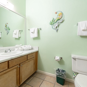 Refresh in this guest bathroom featuring a spacious vanity, plush towels, and cheerful decor
