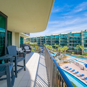 Lounge in stylish seating on the balcony, soaking in the warmth of the sun and tranquil views of the pool