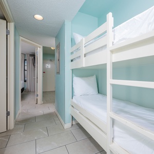 Cozy bunk beds in a softly colored nook create a fun space for kids to rest after a day of adventure