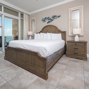 Retreat to the king master suite with cozy bedding and drift off to the sound of the waves from the balcony