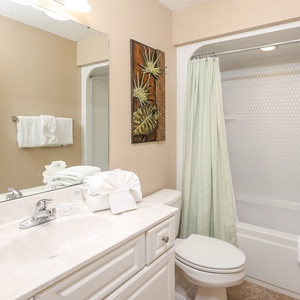Experience the charming tranquility of this guest bath, perfect for refreshing routines before beach outings