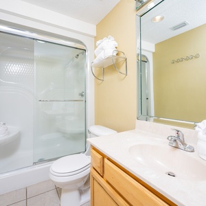 The master bathroom features a spacious vanity, a glass walk-in shower, and fresh towels for your convenience