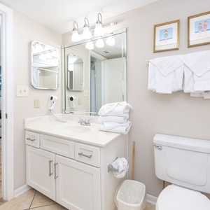 Refresh in the bathroom with a spacious vanity, ample towels, and access from the bedroom and living space
