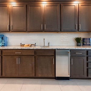 Use the wet bar sink and beverage fridge to chill drinks and enjoy the coastal coral accent