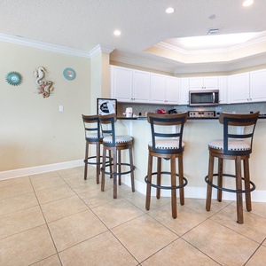 Wake up with morning coffee at the breakfast bar and get ready for a beach day in this stylish space