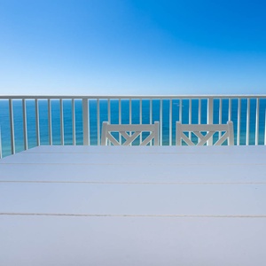 Savor meals at the bright dining table while enjoying expansive views of the stunning waters stretching beyond