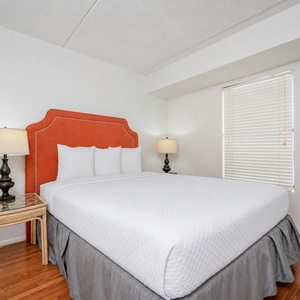 Rest in the plush queen bed with soft linens, enjoying cozy evenings and the gentle glow of your bedside lamps