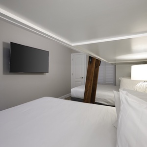 Unwind with a movie in this cozy bunk room with two twins lofted above two queen beds