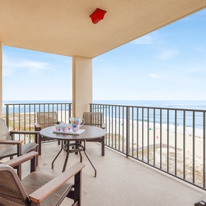 Savor refreshing drinks at the outdoor table while enjoying views of the coastline and gentle waves