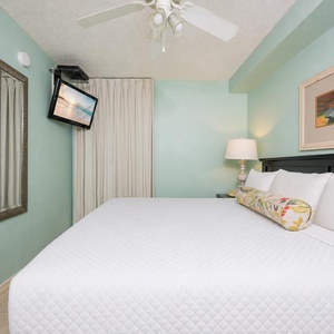 Fluffy pillows invite you to relax in the king suite for a calm movie night after a fun day at the beach