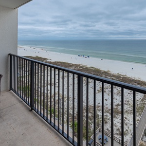 Relax on the cozy balcony with a view of the serene beach and gentle waves, perfect for unwinding