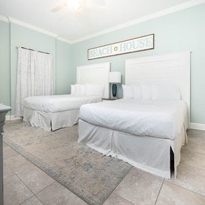 Relax in this cozy queen guest suite, where soft bedding invites restful nights after a day of exploring the coast