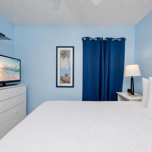 Quiet blue walls wrap your guest suite as you rest on crisp linens and enjoy evening shows on the TV