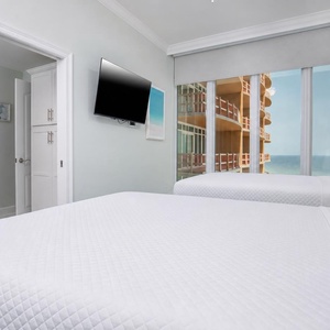 Relax in this guest suite with two cozy queen beds and stunning views from the expansive windows