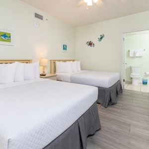 Relax in this guest room with two comfortable double beds, cheerful decor, and a welcoming atmosphere for restful nights