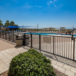 Enjoy the inviting pool area surrounded by lush greenery and comfortable lounge chairs for a relaxing day in the sun