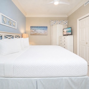 White linens invite restful nights in the king suite while coastal art adds charm to the walls