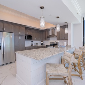Gather, cook and connect in this spacious kitchen featuring stainless steel appliances and seating for four
