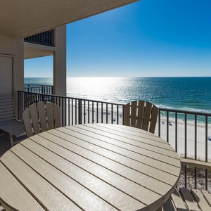 Enjoy meals or drinks at the round table while taking in the expansive beach views from your balcony