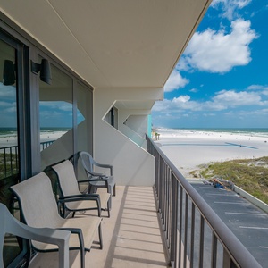 Relax on the spacious balcony with comfortable seating and enjoy expansive views of the pristine pristine beach