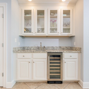 Grab a chilled bottle from the wine cooler or create your favorite cocktail at this elegant wet bar