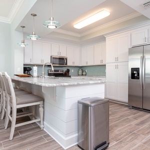 Wake up with morning coffee at the breakfast bar and get ready for a beach day in this stylish space