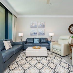 Relax in this inviting living area with plush seating, decorative art, and stunning beach views