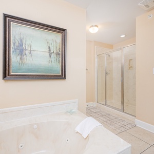 Serene master bathroom featuring a jetted tub, walk-in shower, and calming artwork for a tranquil retreat