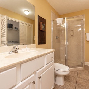 Refresh in this additional guest bath with a walk-in shower and laundry area with a washer and dryer in your rental
