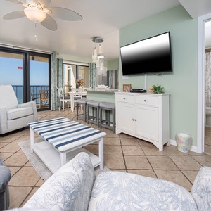 Bright living area featuring comfortable seating, queen sofa-sleeper, a large TV, and breathtaking views from the balcony
