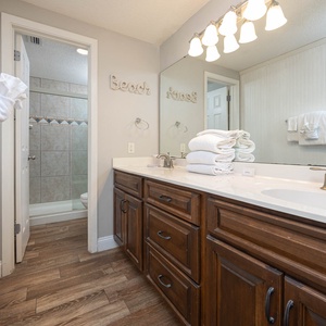 Spacious master bath featuring a double vanity, stylish decor, and walk-in shower area