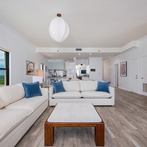 Living space featuring plush sofas, a marble coffee table, and scenic views from large windows