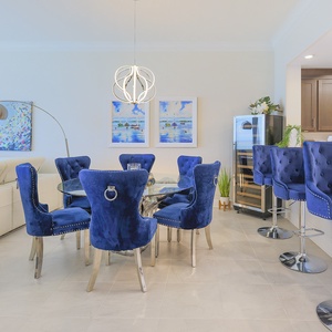 Sink into plush blue chairs at the glass table and grab a chilled bottle from the wine fridge