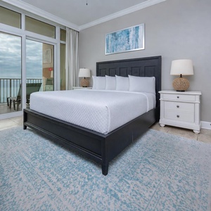 Relax in the serene master suite featuring a comfortable king bed and direct beachfront balcony access