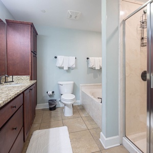 Sleek master bathroom with a spacious vanity, relaxing jetted tub, and walk-in shower