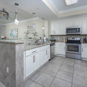 Prepare meals in the stylish kitchen with stainless appliances and a beachfront view