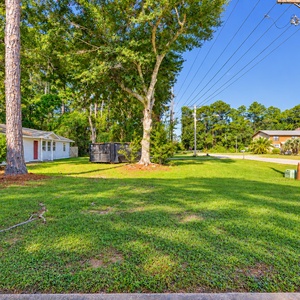 Relax in this spacious backyard featuring a picnic area and grills, perfect for gatherings among the trees