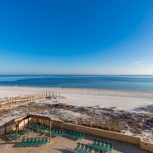 This inviting beach view showcases a serene stretch of white sand and calm waters, perfect for relaxation