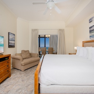 Relax in this inviting master bedroom featuring a plush king bed, cozy twin sleeping chair, and a stunning view