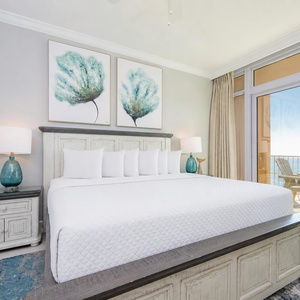 Retreat to the king master suite with cozy bedding and drift off to the sound of the waves from the balcony