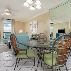 Enjoy meals at the glass dining table surrounded by comfortable seating and a view of the inviting living area